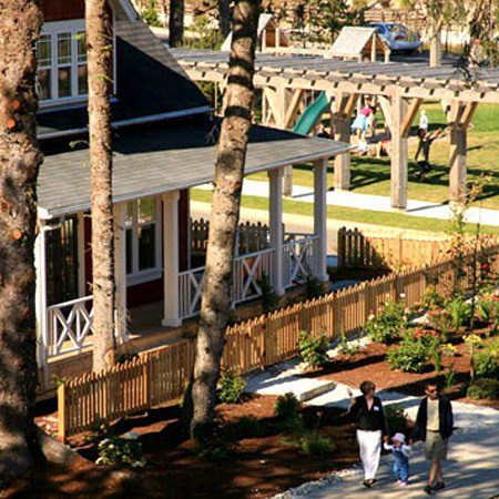 Family walking near house and garden.
